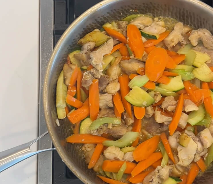 Chicken and vegetable stir-fry cooking in Theodore B.'s Plateful titanium pan